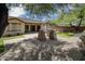 A backyard with desert landscaping, artificial grass, a covered patio, and decorative stone pillars, perfect for outdoor living at 4512 W Rushmore Dr, Anthem, AZ 85087