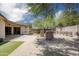 A tranquil backyard featuring desert landscaping, decorative stone pillars, and an outdoor patio for entertaining at 4512 W Rushmore Dr, Anthem, AZ 85087