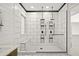 A stylish bathroom showcases a double shower with elegant black-and-white tiling at 4512 W Rushmore Dr, Anthem, AZ 85087
