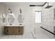 Stylish bathroom with double sink vanity and a double shower featuring elegant black-and-white tiling at 4512 W Rushmore Dr, Anthem, AZ 85087