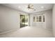 Neutral bedroom with carpet, a ceiling fan, backyard views through windows, and sliding doors to the patio at 4512 W Rushmore Dr, Anthem, AZ 85087