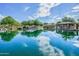 A scenic community pond reflects the sky, trees, and gazebos, creating a peaceful atmosphere for residents to enjoy at 4512 W Rushmore Dr, Anthem, AZ 85087