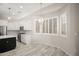 Kitchen dining area showcasing white cabinets, stainless appliances, and modern lighting at 4512 W Rushmore Dr, Anthem, AZ 85087