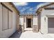 View of home's entrance with a pergola, brick columns and an open front door at 4512 W Rushmore Dr, Anthem, AZ 85087