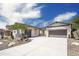 A house with two garages connected by a pergola over the entry at 4512 W Rushmore Dr, Anthem, AZ 85087
