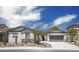 Charming single-story home with desert landscaping, a stone accent wall, and solar panels at 4512 W Rushmore Dr, Anthem, AZ 85087