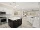 Modern eat-in kitchen featuring a large island, white cabinetry, and stainless steel appliances at 4512 W Rushmore Dr, Anthem, AZ 85087