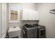 Laundry room featuring a sink, cabinets, and a modern washer and dryer set at 4512 W Rushmore Dr, Anthem, AZ 85087