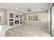 Spacious living room featuring a fireplace, custom built-ins, recessed lighting, and wood-look flooring at 4512 W Rushmore Dr, Anthem, AZ 85087