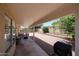 Spacious covered patio area and low-maintenance backyard with private brick wall at 4558 E Libby St, Phoenix, AZ 85032