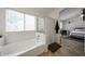 Bright bathroom has a large soaking tub next to window and access to the main bedroom at 4558 E Libby St, Phoenix, AZ 85032
