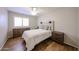 Comfortable bedroom with hardwood floors, rustic-style furniture, ceiling fan, and a bright window at 4558 E Libby St, Phoenix, AZ 85032