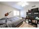 Bedroom featuring a cozy bed, media center, and a decorative guitar, creating a personalized retreat at 4558 E Libby St, Phoenix, AZ 85032