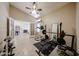 Well-equipped home gym with ample space, weightlifting equipment, ceiling fan, and a view to a sitting room at 4558 E Libby St, Phoenix, AZ 85032