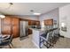 Spacious kitchen with a granite countertop island, stainless steel appliances, and ample cabinets at 4558 E Libby St, Phoenix, AZ 85032