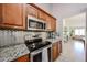 Modern kitchen boasts stainless steel appliances, granite countertops, and tile backsplash at 4558 E Libby St, Phoenix, AZ 85032