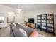 Comfortable living room featuring a large sofa, modern entertainment center, and plenty of natural light at 4558 E Libby St, Phoenix, AZ 85032