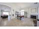 Open living room featuring a fireplace, dining area, and neutral color palette at 4558 E Libby St, Phoenix, AZ 85032