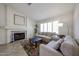 Comfortable living room featuring a fireplace, neutral seating, and ample natural light at 4558 E Libby St, Phoenix, AZ 85032