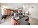 Open-concept space featuring a dining area, kitchen with bar seating, and a living room with a large sofa at 4558 E Libby St, Phoenix, AZ 85032