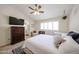 Bright main bedroom with a large window, comfortable seating area, and a view into the bathroom at 4558 E Libby St, Phoenix, AZ 85032