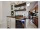 Stylish wine bar with a beverage cooler, wooden countertop, and floating shelves at 4558 E Libby St, Phoenix, AZ 85032
