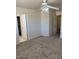 Bedroom features neutral carpet, a ceiling fan, and access to a walk-in closet at 5122 E Shadow Ln, San Tan Valley, AZ 85140