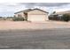 Inviting single-level home featuring an attached garage, desert landscaping, and quaint curb appeal at 5122 E Shadow Ln, San Tan Valley, AZ 85140