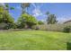 Large backyard with lush lawn and mature trees offering shade, ideal for outdoor activities and enjoying the natural surroundings at 5330 E Tierra Buena Ln, Scottsdale, AZ 85254