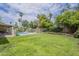 Expansive backyard featuring a well-maintained lawn, mature trees, and a refreshing pool area, perfect for outdoor enjoyment at 5330 E Tierra Buena Ln, Scottsdale, AZ 85254