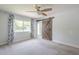 Bedroom featuring neutral carpet, a ceiling fan, and a decorative sliding barn door at 5330 E Tierra Buena Ln, Scottsdale, AZ 85254