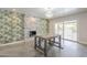 Bright dining area featuring a decorative fireplace, a modern chandelier, and access to a pool at 5330 E Tierra Buena Ln, Scottsdale, AZ 85254