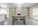 Open dining area featuring a decorative fireplace, a modern chandelier, and views of the exterior at 5330 E Tierra Buena Ln, Scottsdale, AZ 85254