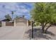 Single story home featuring desert landscaping, mature trees, and wide driveway at 5330 E Tierra Buena Ln, Scottsdale, AZ 85254