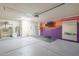 Spacious garage with vibrant mural, ample storage, and potential for a home gym or workshop at 5330 E Tierra Buena Ln, Scottsdale, AZ 85254