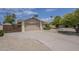 Wide driveway leading to a two car garage, desert landscaping and gated side yard at 5330 E Tierra Buena Ln, Scottsdale, AZ 85254