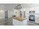 Bright kitchen features white cabinetry, stainless steel appliances, and a butcher block island at 5330 E Tierra Buena Ln, Scottsdale, AZ 85254