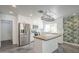 Bright kitchen features white cabinetry, stainless steel appliances, and a butcher block island at 5330 E Tierra Buena Ln, Scottsdale, AZ 85254