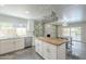 Bright kitchen featuring white cabinets, a butcher block island, and views of the dining area at 5330 E Tierra Buena Ln, Scottsdale, AZ 85254