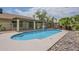 Backyard pool surrounded by rocks and grass, adjacent to covered patio at 5330 E Tierra Buena Ln, Scottsdale, AZ 85254