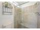 Shower stall featuring decorative tile work and clear glass doors at 5330 E Tierra Buena Ln, Scottsdale, AZ 85254