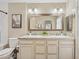 Bathroom with a double sink vanity, decorative mirror, and soft lighting at 5415 E Juniper Ave, Scottsdale, AZ 85254