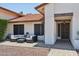 Inviting entryway with a cozy patio seating area and decorative front door at 5415 E Juniper Ave, Scottsdale, AZ 85254
