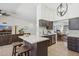 Modern kitchen boasts a large island with seating, stainless steel appliances, and an open layout at 5415 E Juniper Ave, Scottsdale, AZ 85254