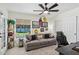 Living room featuring a plush sofa, decorative pillows, and a view of the backyard at 5415 E Juniper Ave, Scottsdale, AZ 85254