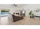 Cozy living room featuring a white fireplace, sliding glass door access to the pool, and tile flooring at 5415 E Juniper Ave, Scottsdale, AZ 85254