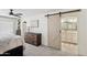 Bedroom with a barn door opening to the bathroom and a view of the closet area at 5415 E Juniper Ave, Scottsdale, AZ 85254