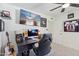 Office area with a large monitor, gaming chair, and guitar, for a creative and functional workspace at 5415 E Juniper Ave, Scottsdale, AZ 85254