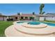 Lush backyard features a uniquely shaped pool, patio with lounge seating, and large grassy area at 5415 E Juniper Ave, Scottsdale, AZ 85254