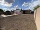 Backyard with low-maintenance gravel landscaping with pool and covered patio at 5539 W Wilshire Dr, Phoenix, AZ 85035